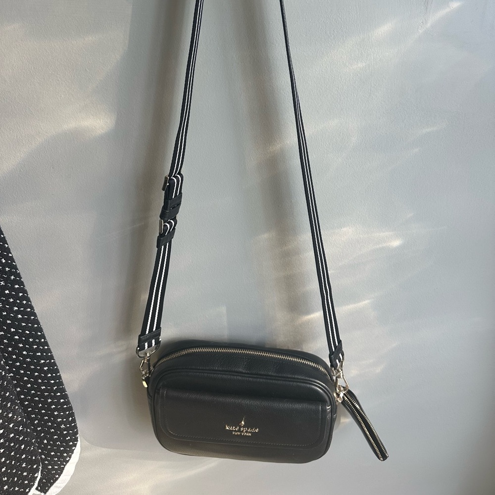 Kate Spade crossbody purse with active sport black and white strap.
